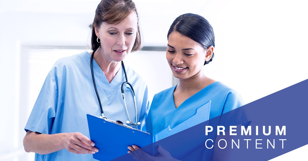 Doctor and a nurse viewing information from a clipboard folder